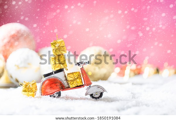 Vintage red toy motorbike with\
christmas gifts in the snow. Xmas and Happy New Year theme. Copy\
space