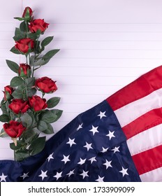 Vintage red, white, and blue American flag for Memorial day, 4th of July  or Veteran's day with red roses on a white background.