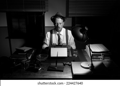 Vintage Reporter Working Late At Night Typing On Typewriter.