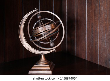 Vintage retro classic zodiac globe armillary sphere model. Antique celestial sphere on dark wooden back ground