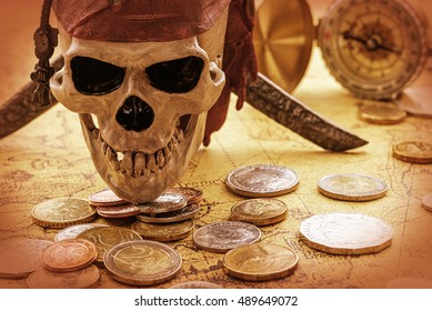 Vintage / retro color style : Skull and coins on an ancient map and an old brass compass behind. An idea of guarding / keeping / hiding treasure from robbing by robbers / thieves or treasure hunters.