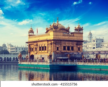 Vintage retro effect filtered hipster style image of famous indian toursit landmark and sacred pilgrimage site - Sikh gurdwara Golden Temple (Harmandir Sahib). Amritsar, Punjab, India