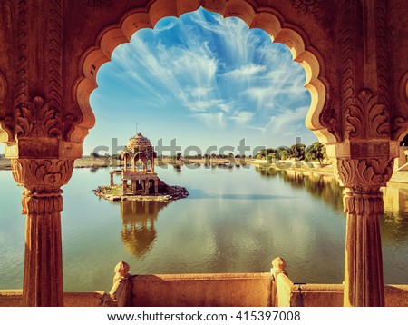 Vintage retro effect filtered hipster style image of Indian landmark Gadi Sagar - artificial lake view through arch. Jaisalmer, Rajasthan, India