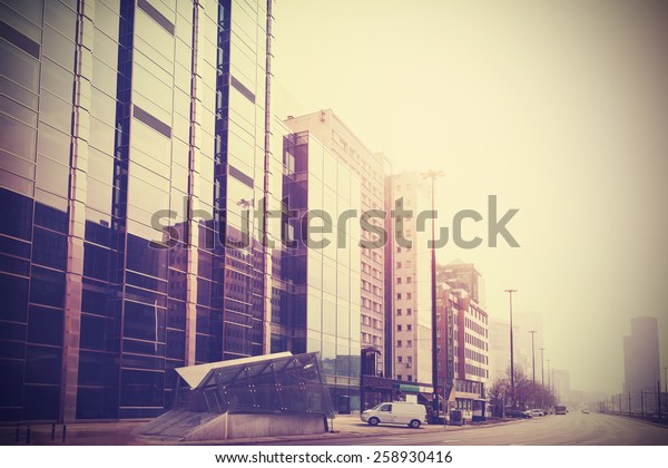 Vintage retro filtered picture of modern downtown\
in Warsaw, Poland.