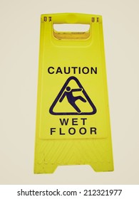 Vintage Retro Looking Caution Wet Floor Sign Isolated On White