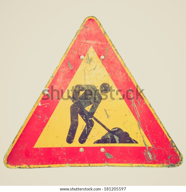 Vintage retro looking Road
works sign for construction works in progress - isolated over white
background