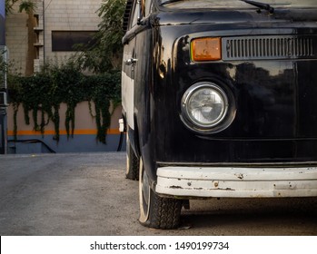 Vintage, Retro Old Black Bus With One Light, Parked With A Flat Tyre