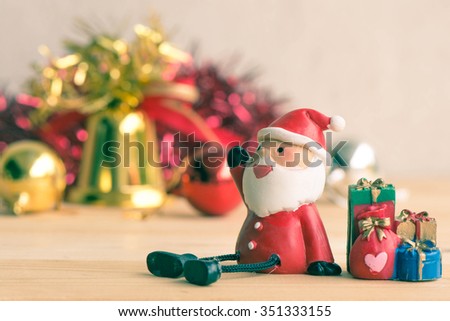 Vintage retro picture style - Santa Claus sitting on wood table