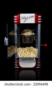 A Vintage Retro Popcorn Machine Over Black Background