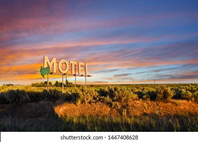 Vintage roadside highway Motel advertising sign seen through a colorful sunset in the American Desert of the Inland Northwest.
