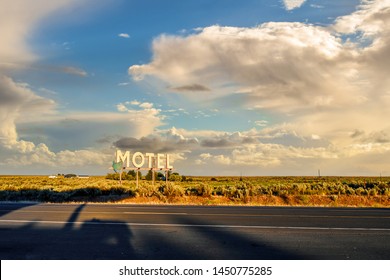 Vintage roadside highway Motel advertising sign on an overcast, partly cloudy day in the American Desert of the Inland Northwest.