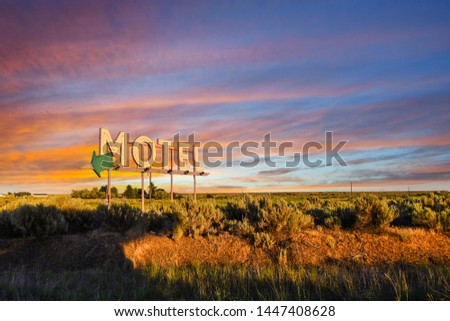 Vintage roadside highway Motel advertising sign seen through a colorful sunset in the American Desert of the Inland Northwest.