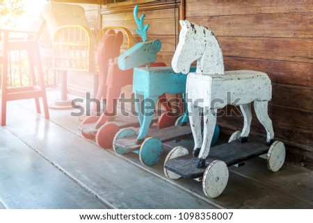 Vintage rocking animal in old house. Old rustic toy in wooden house