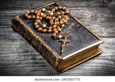 Vintage rosary beads on old holly Bible - Powered by Shutterstock