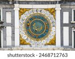 Vintage round zodiac, astrological calendar on the wall of an old building in the city of Brescia. Macro. Horizontal photo