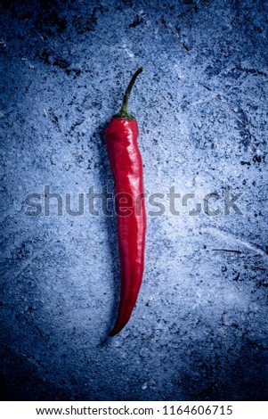 Vintage rustic background with chilli peper. Toned picture