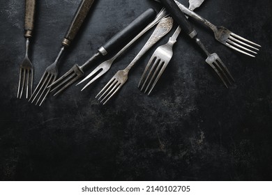 Vintage Rustic Cutlery On Dark Old Background. 