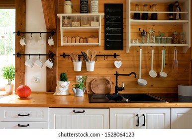 Vintage Rustic Interior Of Kitchen With White Furniture, Wooden Wall And Rustical Decor. Bright Indoor.