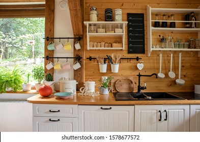 Vintage rustic interior of kitchen with white furniture, wooden wall and rustical decor. Bright indoor with window. Cottage interior and style. - Shutterstock ID 1578677572