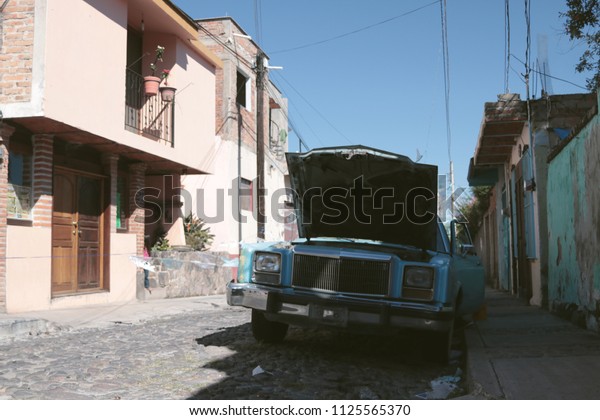 Vintage rusty car in a road of a mexican town,\
Ajijic, Jalisco, Mexico