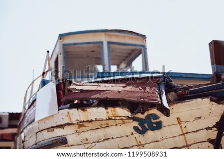 Vintage rusty old boat background. Damaged abandoned old-fashion boat, vintage ruined sailing ship wreck concept. Retired retro styled boat, outdated sea water vehicle. Shipwreck horizontal wallpaper 