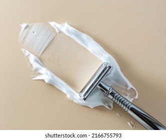 Vintage safety metal razor, with smeared shaving foam on a beige background. copy space and flatlay. - Powered by Shutterstock