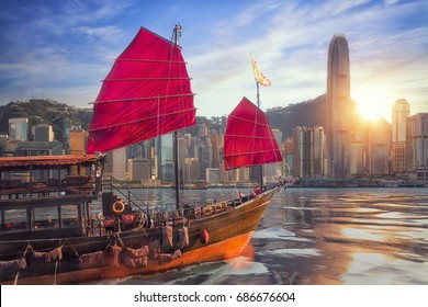 Vintage Sail Boat Fron Victoria Port To Hongkong Harbour For Survice To Tourist In Hong Kong Coty With Sunset And Blue Sky, China, Travel Asia And Cityscape Concept