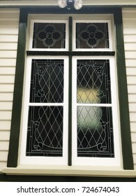 Vintage sash window with diamond pane lead lights. Delicate art nouveau tracery adds decoration to this lovely retro window.