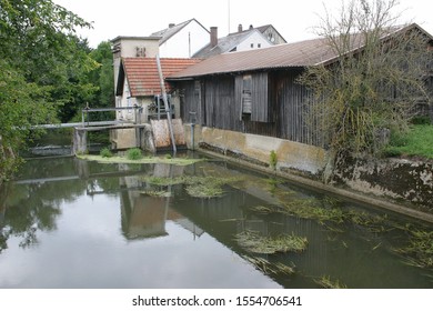 Vintage Saw Mill With Reflection In River
