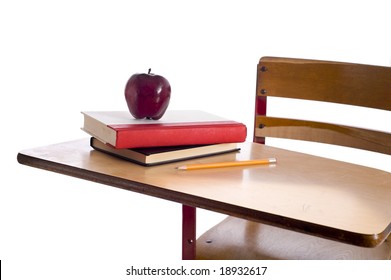 A Vintage School Desk With School Books, A Red Apple And A Pencil On A White Background With Copy Space