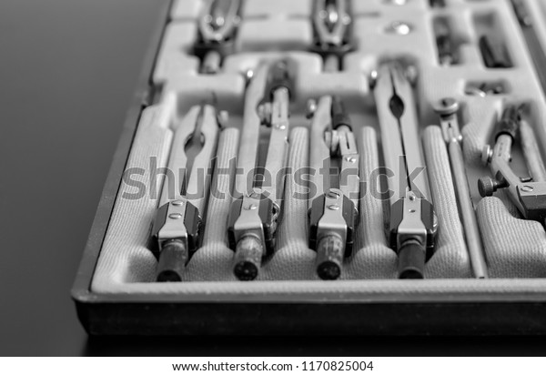 Vintage set\
of drawing tools (opened box with drawing instruments), monochrome\
image, selective focus,\
close-up