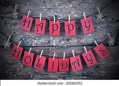 Vintage Or Shabby Chic Wooden Rustic Background. Red Tags With Happy Holidays Hanging On A Line. Snowflakes Hanging On Cloth Pegs. Christmas Card For Seasons Greetings. Frame For Night Style - Shutterstock ID 323363351