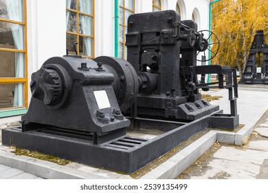 Vintage sheet-rolling cage from the end of XIX century, old black industrial machine, close-up photo with selective focus - Powered by Shutterstock