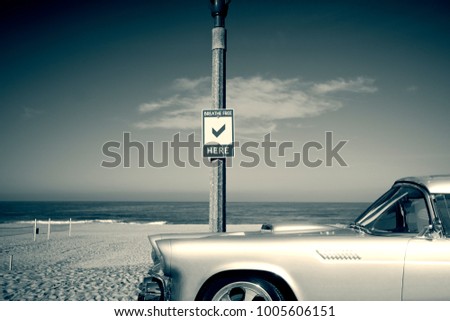 Vintage shiny silver car with background of beach