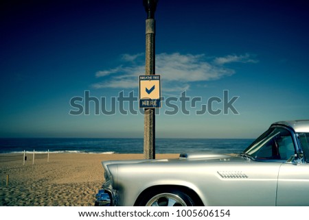 Vintage shiny silver car with background of beach