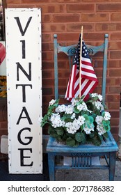 The Vintage Sign Is Outside The Antique Store.