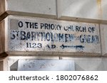 A vintage sign pointing people to the direction of the historic St. Bartholomew the Great church in the City of London, UK.