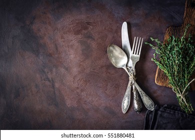 Vintage silverware on a dark textile and bunch of fresh thyme on dark rusty background. Top view, copy space for text. - Powered by Shutterstock