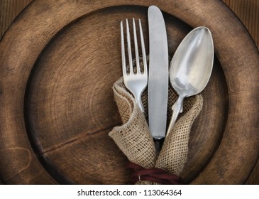 Vintage silverware on rustic wooden plate - Powered by Shutterstock