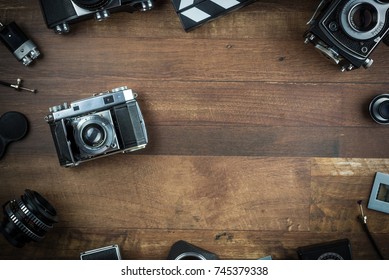 vintage single lens reflex folding camera on a wooden background - Powered by Shutterstock