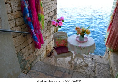 Vintage sitting place by the sea in medieval, romantic town of Rovinj in narrow stone street, Istria, Croatia