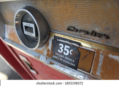 A Vintage Soda Vending Machine In Soft Focus, With The 35¢ Price Point In Clear View