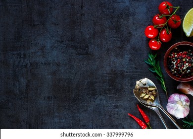 Vintage spoon and vegetables for cooking on dark metal background with space for text. Top view. Bio Healthy food ingredients. 