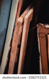 Vintage Stack of Frames on a Shelf. High quality photo. A horizontal photograph featuring a stack of picture frames carefully arranged on a shelf. The image has a vintage-style edit, enhancing the