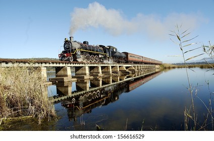 Vintage Steam Train On A Bridge Traveling Between George And Knysna, Garden Route, South Africa