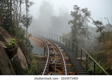 Vintage steel train railway in the hill in the mist, path to unclear foggy destination
