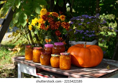 Vintage Still Life With Jars Of Pumkin Jam And Fall Flowers On The Old Table In The Garden Outside, Thanksgiving Day And Calendar Autumn Concept Background