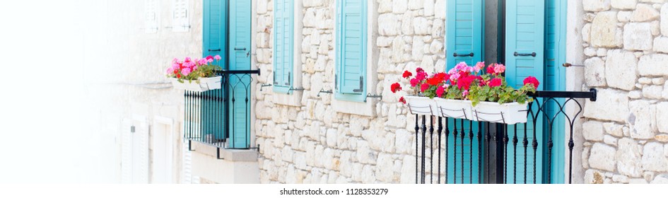 Vintage Stone House Facade with Windows  Blue Wooden Shutters, Flowers Decorated  - Powered by Shutterstock