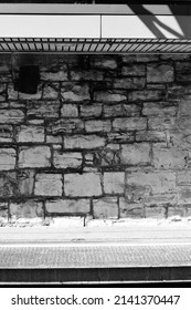 Vintage Stone Wall Of An Old Inner City Building Suffering From Decades Of Neglect In Black And White..