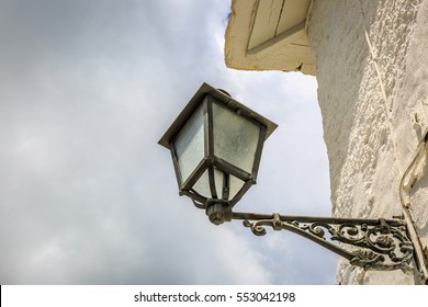 Vintage Streetlight On The White Wall Of A Rural House